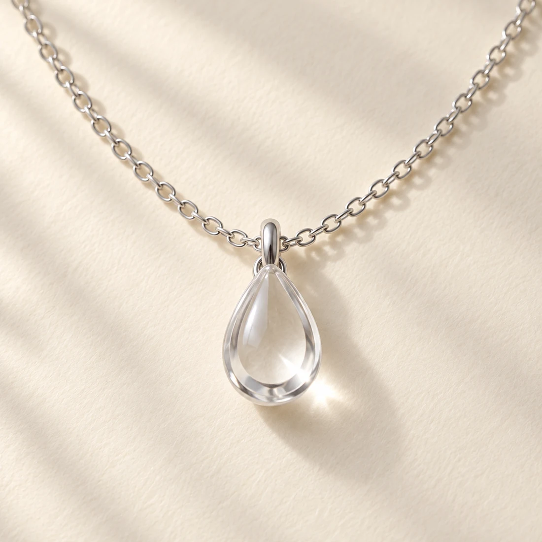 Shizuku Drop Necklace: close-up of the Silver / Clear pendant