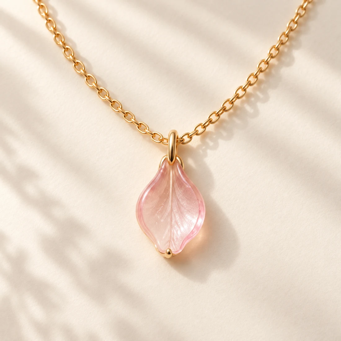 Sakura Petal Necklace: close-up of the Gold / Blush pendant
